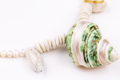 Sea Waves Necklace - Green Oana Savu Sea shells necklace. This handmade one of a kind necklace has an unique big shell as a center piece, freshwater pearls, 2 special and rare shells and tiny sand dollars which I handpicked from a beach in Knokke Heist Belgium. It has a sterling silver clasp and extension chain. This necklaces collection is perfect for your holiday summer escape.