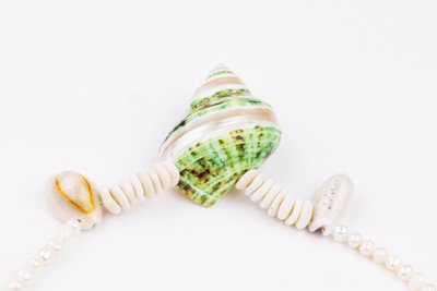 Sea Waves Necklace - Green Oana Savu Sea shells necklace. This handmade one of a kind necklace has an unique big shell as a center piece, freshwater pearls, 2 special and rare shells and tiny sand dollars which I handpicked from a beach in Knokke Heist Belgium. It has a sterling silver clasp and extension chain. This necklaces collection is perfect for your holiday summer escape.
