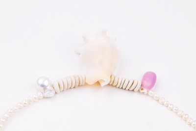Sea Waves Necklace - Purple Oana Savu Sea shells necklace. This handmade one of a kind necklace has an unique big shell as a center piece, freshwater pearls, 2 special and rare shells and tiny sand dollars which I handpicked from a beach in Knokke Heist Belgium. It has a sterling silver clasp and extension chain. This necklaces collection is perfect for your holiday summer escape.