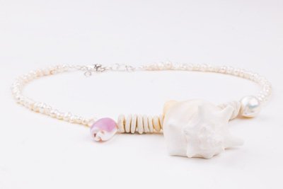 Sea Waves Necklace - Purple Oana Savu Sea shells necklace. This handmade one of a kind necklace has an unique big shell as a center piece, freshwater pearls, 2 special and rare shells and tiny sand dollars which I handpicked from a beach in Knokke Heist Belgium. It has a sterling silver clasp and extension chain. This necklaces collection is perfect for your holiday summer escape.