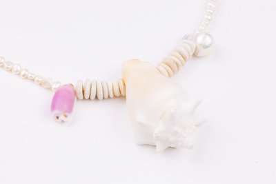 Sea Waves Necklace - Purple Oana Savu Sea shells necklace. This handmade one of a kind necklace has an unique big shell as a center piece, freshwater pearls, 2 special and rare shells and tiny sand dollars which I handpicked from a beach in Knokke Heist Belgium. It has a sterling silver clasp and extension chain. This necklaces collection is perfect for your holiday summer escape.