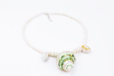 Sea Waves Necklace - Green Oana Savu Sea shells necklace. This handmade one of a kind necklace has an unique big shell as a center piece, freshwater pearls, 2 special and rare shells and tiny sand dollars which I handpicked from a beach in Knokke Heist Belgium. It has a sterling silver clasp and extension chain. This necklaces collection is perfect for your holiday summer escape.