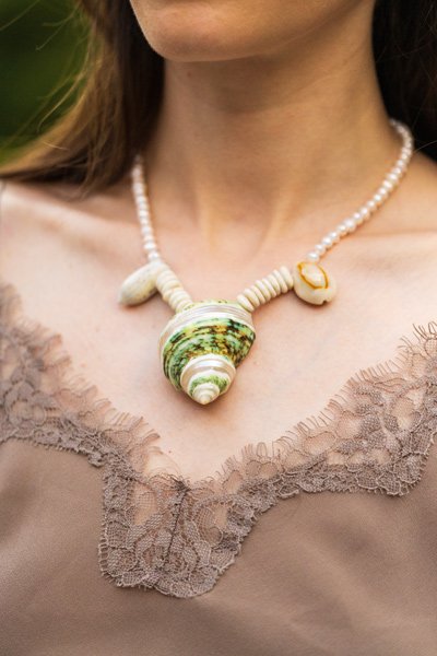 Sea Waves Necklace - Green Oana Savu Sea shells necklace. This handmade one of a kind necklace has an unique big shell as a center piece, freshwater pearls, 2 special and rare shells and tiny sand dollars which I handpicked from a beach in Knokke Heist Belgium. It has a sterling silver clasp and extension chain. This necklaces collection is perfect for your holiday summer escape.