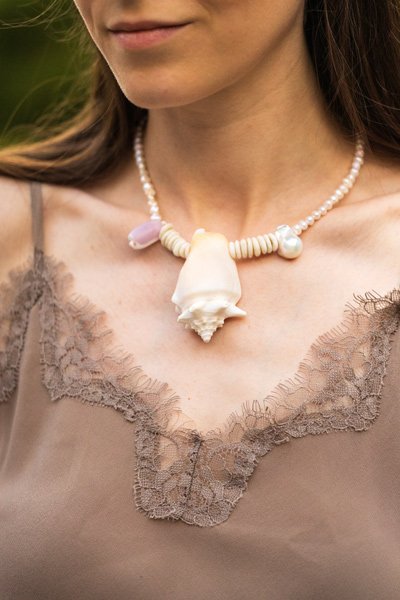 Sea Waves Necklace - Purple Oana Savu Sea shells necklace. This handmade one of a kind necklace has an unique big shell as a center piece, freshwater pearls, 2 special and rare shells and tiny sand dollars which I handpicked from a beach in Knokke Heist Belgium. It has a sterling silver clasp and extension chain. This necklaces collection is perfect for your holiday summer escape.