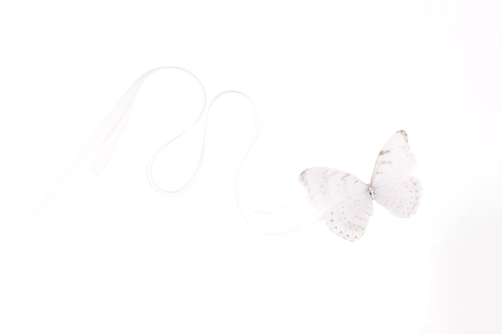 Butterfly Ribbon Tie - Off White Oana Savu Handmade ribbon tie accessory is sewn by hand in our little atelier near in Antwerp, Belgium. The voluminous silk butterfly worn around your neck, frames the face, adding a spark of ingenuity to any look. It is sewn on a high-quality silk satin ribbon tie, with a customizable length to fit more styles, worn around your neck - as a choker necklace, style your hair oh hot summer days, around your wrist as a bracelet or even around your waist as a belt for those light summer dresses.