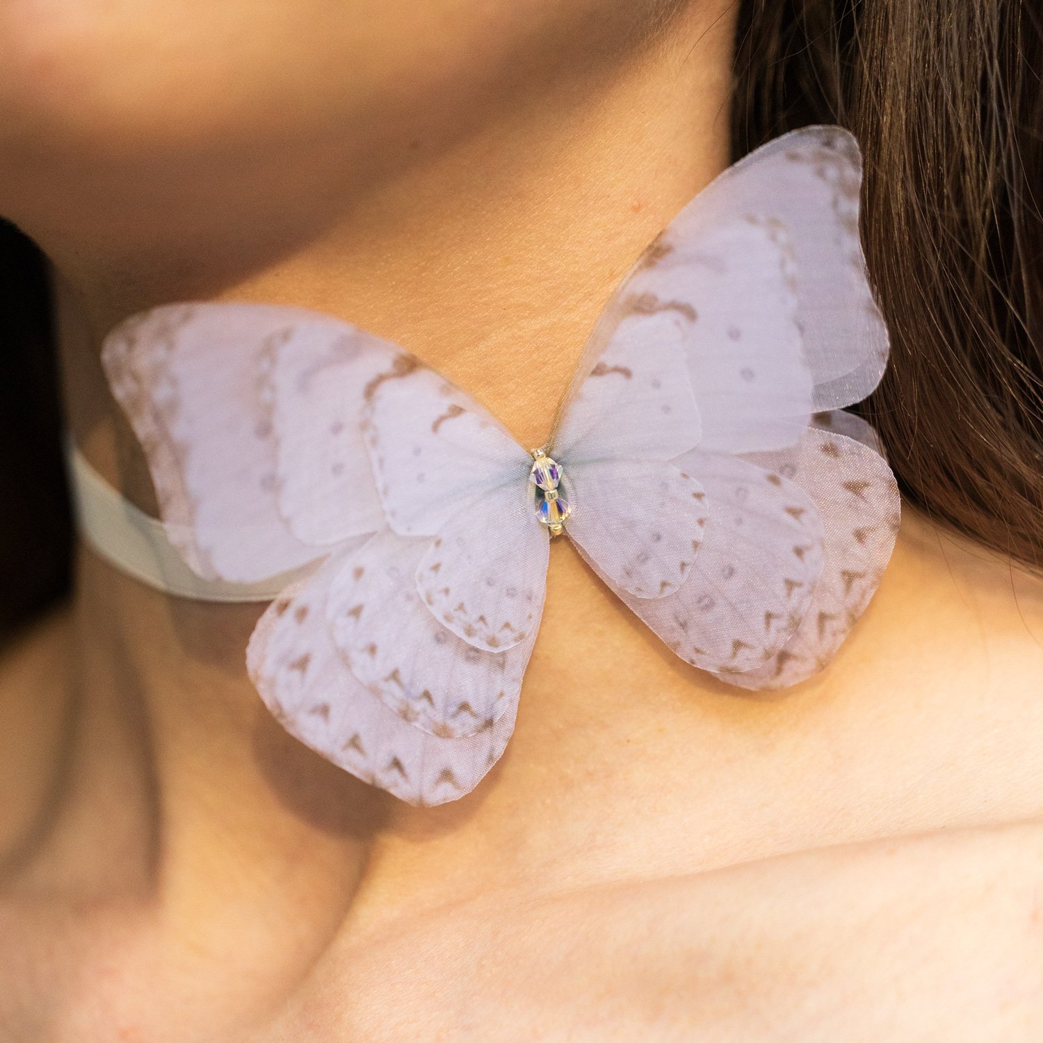 Butterfly Ribbon Tie - Off White Oana Savu Handmade ribbon tie accessory is sewn by hand in our little atelier near in Antwerp, Belgium. The voluminous silk butterfly worn around your neck, frames the face, adding a spark of ingenuity to any look. It is sewn on a high-quality silk satin ribbon tie, with a customizable length to fit more styles, worn around your neck - as a choker necklace, style your hair oh hot summer days, around your wrist as a bracelet or even around your waist as a belt for those light summer dresses.