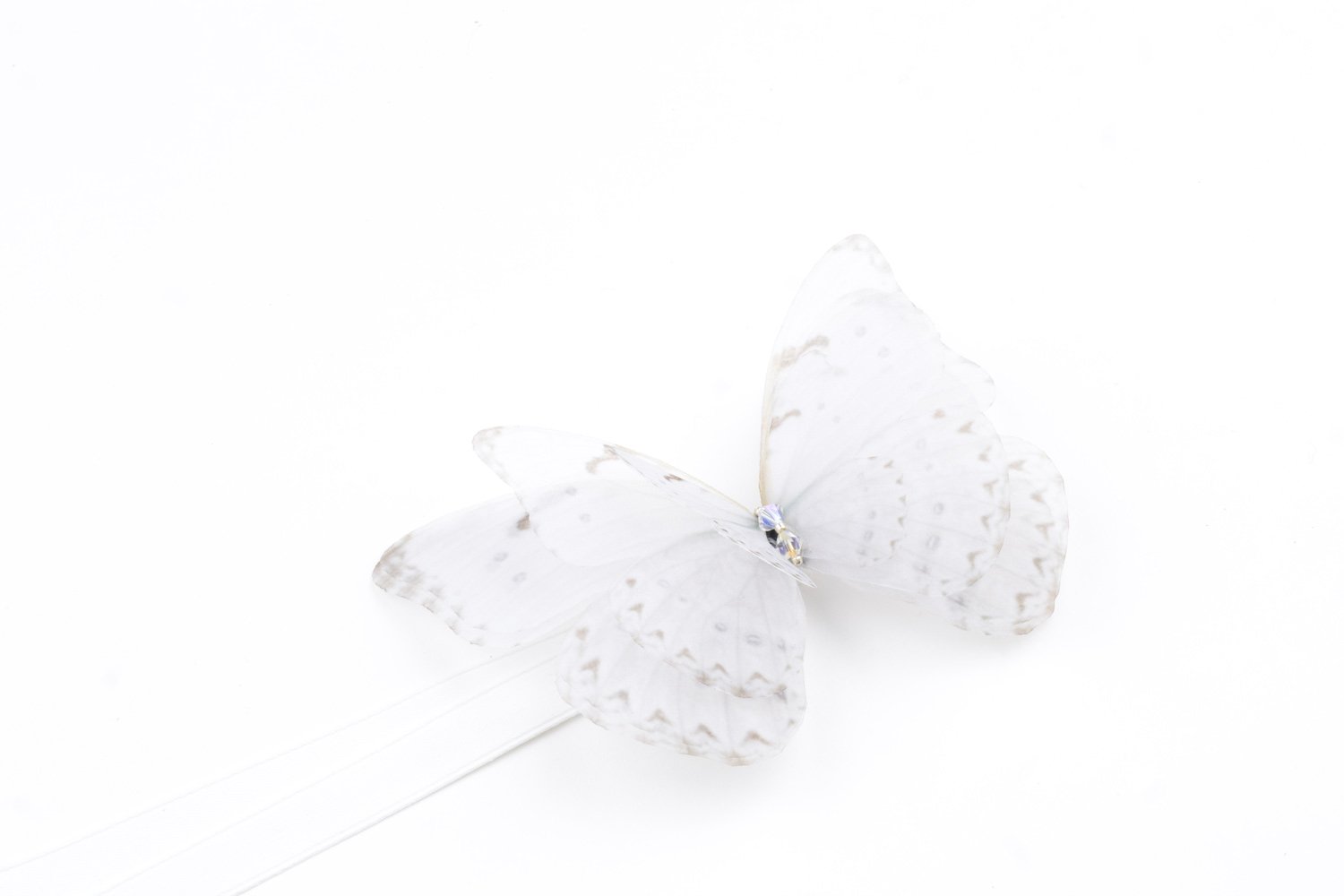 Butterfly Ribbon Tie - Off White Oana Savu This handmade ribbon tie accessory is meticulously crafted with precision, capturing the likeness of a real butterfly. A versatile accessory that can be worn in multiple ways. Whether styled around your neck as a choker necklace or worn adorning the hair, it fastens with a silk ribbon tie, making the fit fully customizable. The white butterfly and ribbon color makes this accessory suitable for a bride as well, plus, it can be successfully worn after the wedding as well, styling your daily outfits with your favorite accessory.