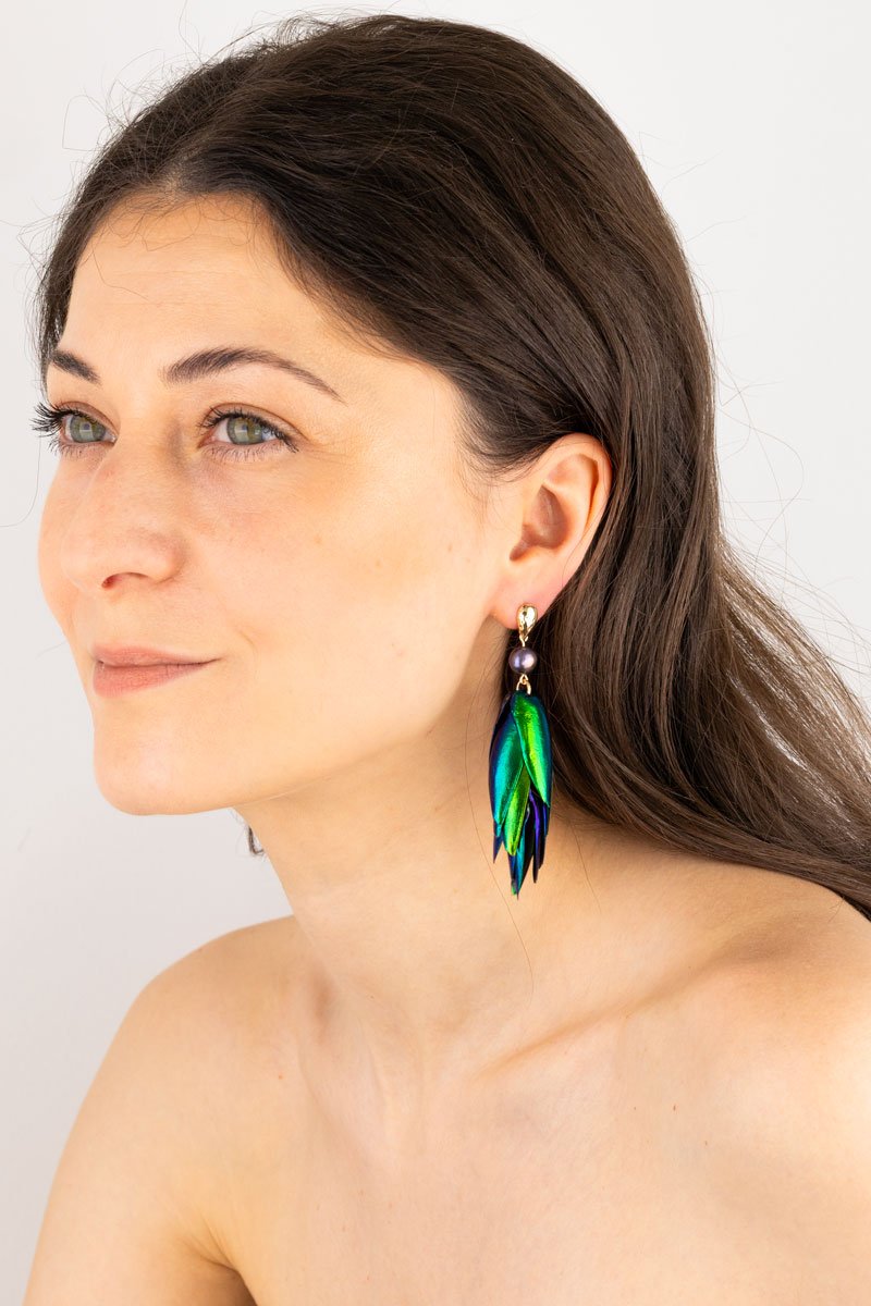 Beetle Earrings Drop Ear Studs- Peacock Pearls Oana Savu Close-up of peacock pearl beetle earrings showing colorful reflections on a model